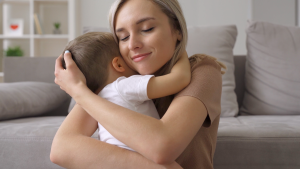 mom hugging child Mother hugging her child.